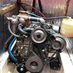Slide: The Image of Engine of a 1984 Hunter 31 sailboat, showcasing mechanical components and hoses. - 21