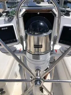 Slide: The Image of 1984 Hunter 31 sailboat cockpit with steering wheel and navigation instruments. - 26