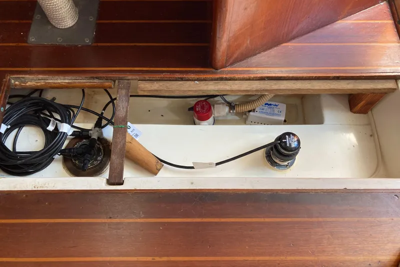 Slide: The Image of 1984 Hunter 31 sailboat interior wiring and components under wooden deck. - 36
