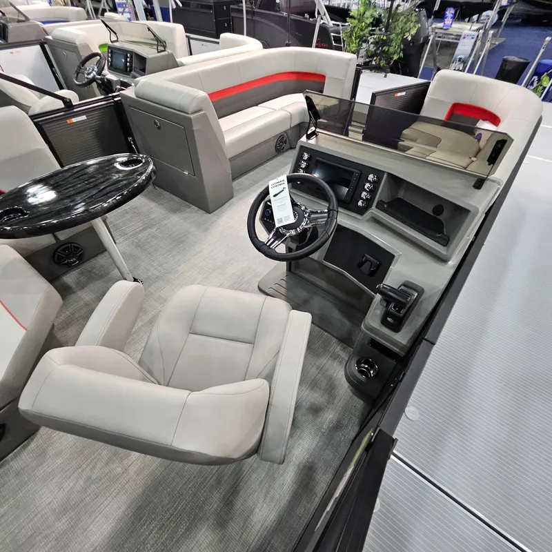 Slide: The Image of Interior of 2025 Qwest E 20XRE pontoon boat with modern seating and steering console. - 15