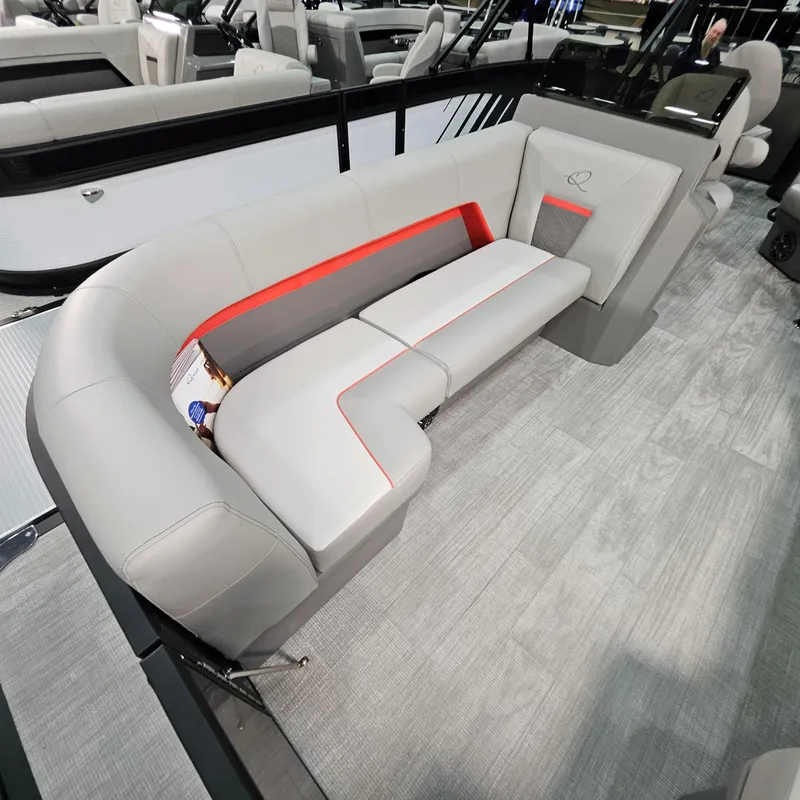 Slide: The Image of Luxurious seating in 2025 Qwest E 20XRE boat, featuring modern gray upholstery and red accents. - 19