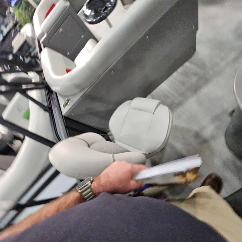 Slide: The Image of Interior view of a 2025 Qwest E 20XRE boat with seating and steering area. - 29