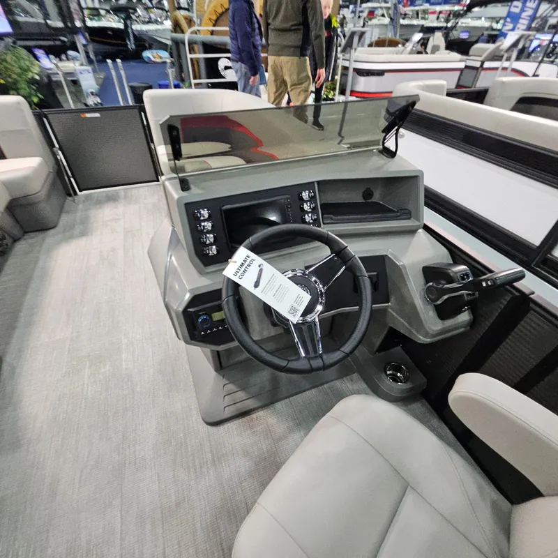 Slide: The Image of 2025 Qwest E 20XRE boat interior with modern steering console and seating. - 30