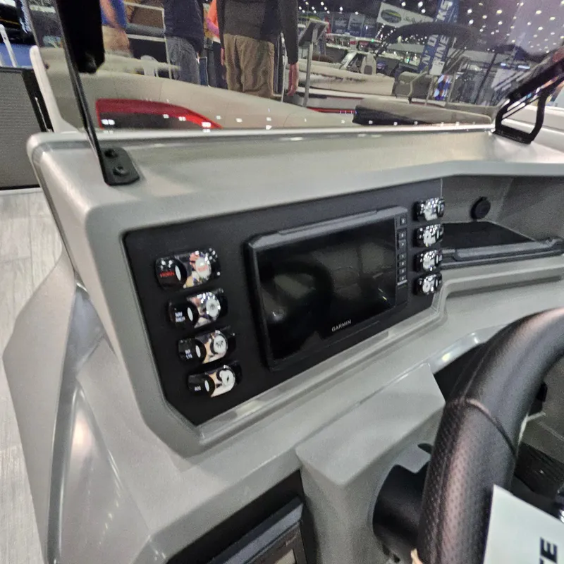 Slide: The Image of Dashboard of 2025 Qwest E 20XRE boat with control panel and display screen. - 32