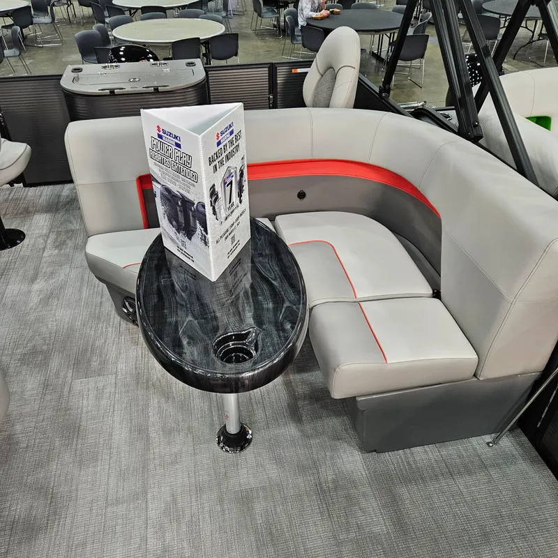 Slide: The Image of Luxurious seating area in 2025 Qwest E 20XRE boat with modern table and brochure. - 4
