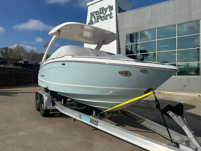 Slide: The Image of 2022 Regal LS4 Surf boat on trailer outside Kelly's Port dealership. - 0