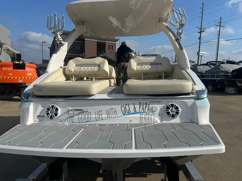 Slide: The Image of 2022 Regal LS4 Surf boat with custom seating and speakers, docked outdoors. - 13