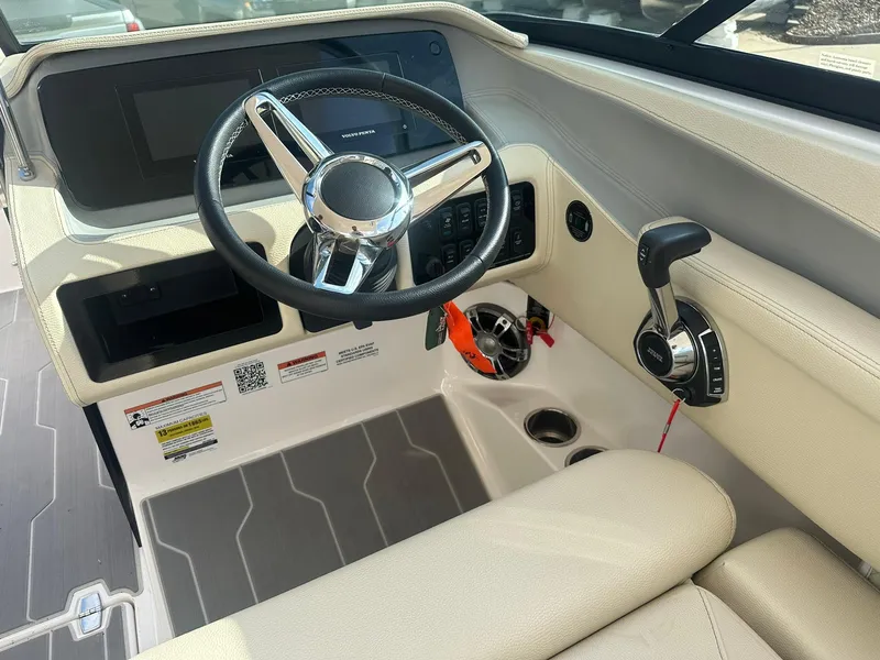 Slide: The Image of 2022 Regal LS4 Surf boat cockpit with steering wheel and controls. - 15