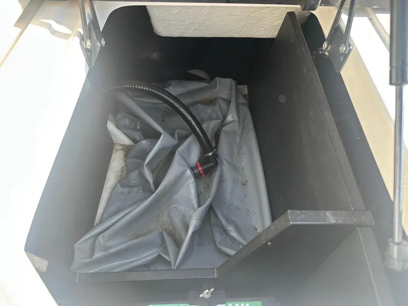 Slide: The Image of Storage compartment of 2022 Regal LS4 Surf boat with hose and cover. - 22
