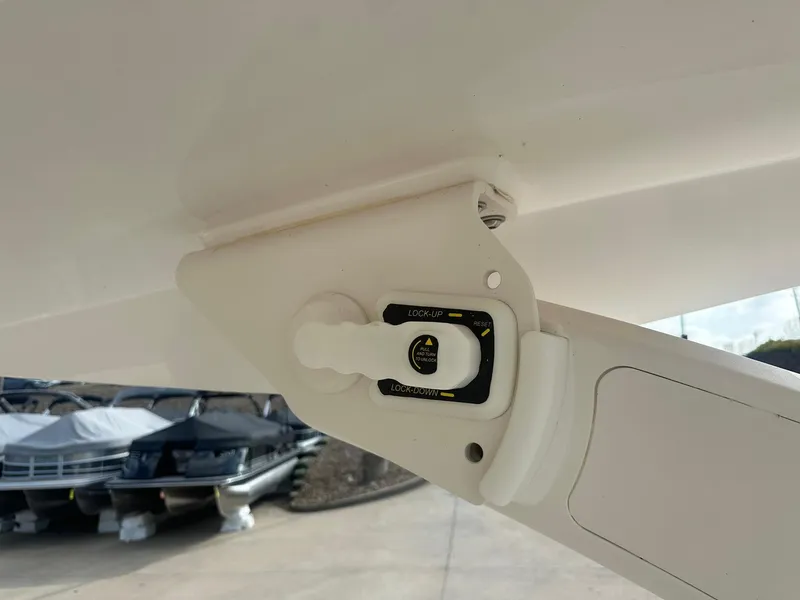 Slide: The Image of 2022 Regal LS4 Surf boat detail, showcasing a control mechanism in a marina setting. - 24