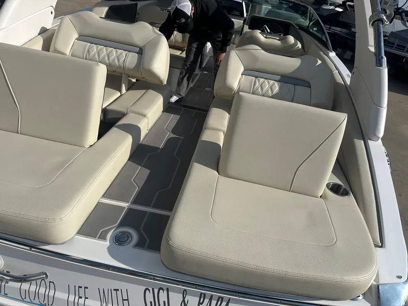 Slide: The Image of 2022 Regal LS4 Surf boat with beige seating and spacious deck layout. - 27