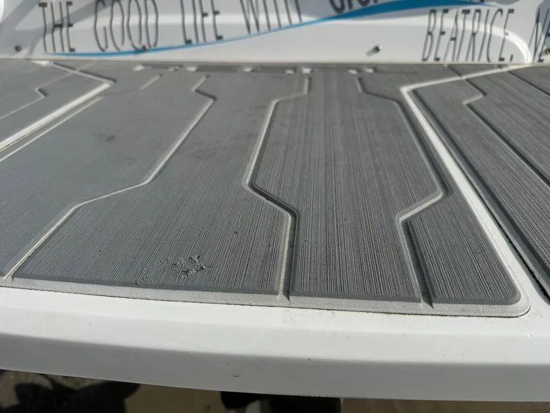 Slide: The Image of 2022 Regal LS4 Surf boat deck with textured gray surface. - 28