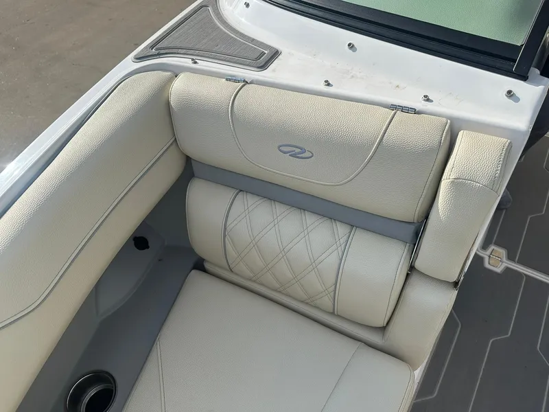 Slide: The Image of 2022 Regal LS4 Surf boat interior with beige leather seating and cup holder. - 29