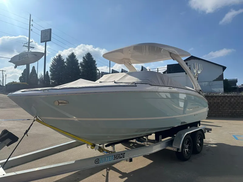 Slide: The Image of 2022 Regal LS4 Surf boat on trailer under clear sky. - 3
