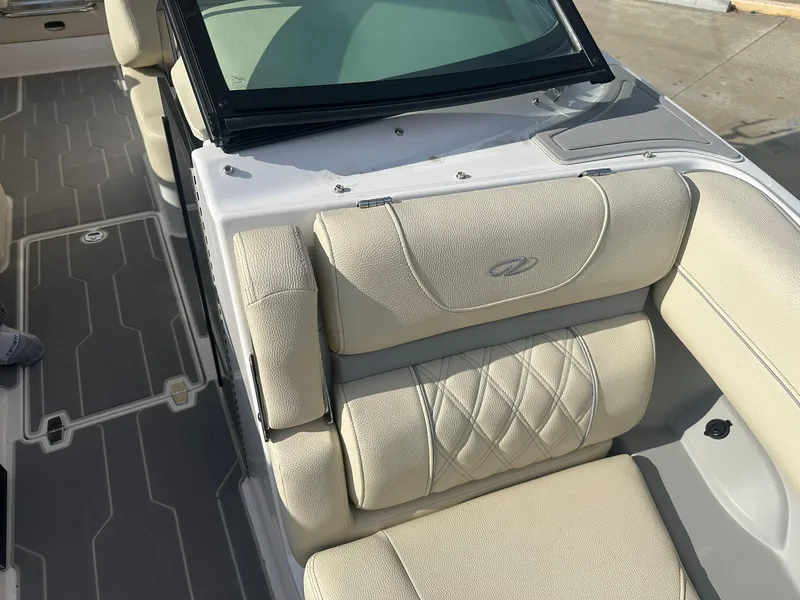 Slide: The Image of 2022 Regal LS4 Surf boat with beige cushioned seating and sleek design. - 35