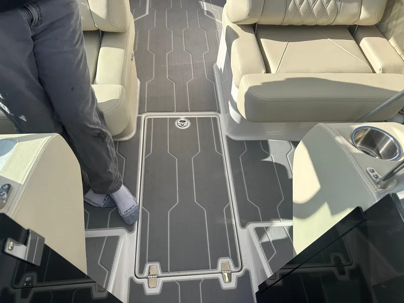 Slide: The Image of 2022 Regal LS4 Surf boat interior with gray flooring and beige seating. - 36
