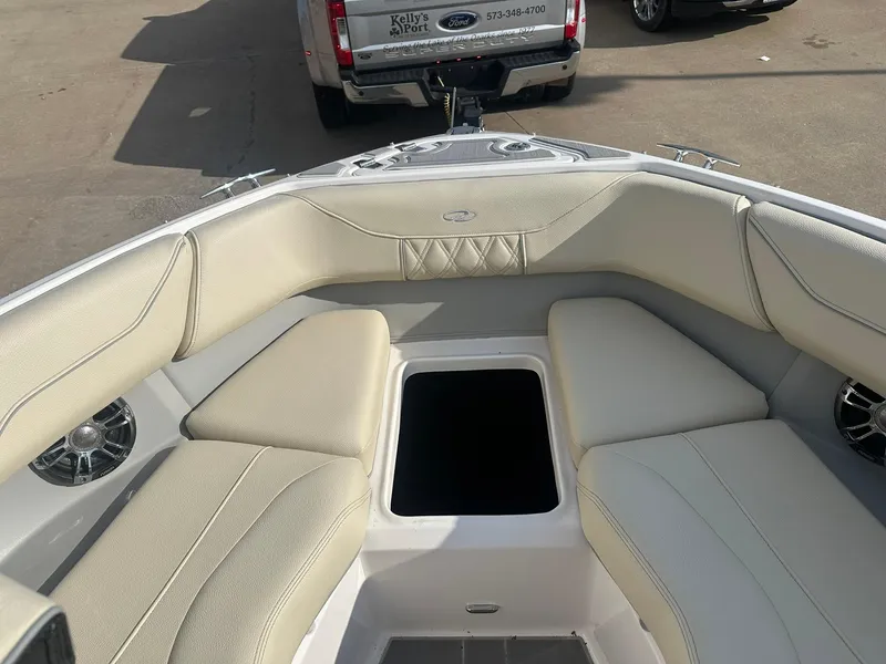 Slide: The Image of 2022 Regal LS4 Surf boat interior with beige seating and storage compartment. - 4