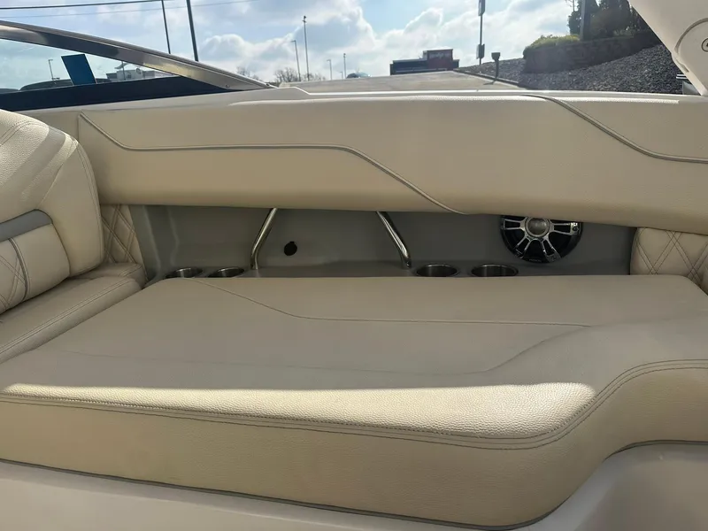 Slide: The Image of 2022 Regal LS4 Surf boat interior with beige seating and cup holders. - 42