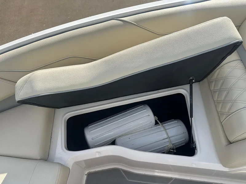 Slide: The Image of 2022 Regal LS4 Surf boat storage compartment with white fenders inside. - 6