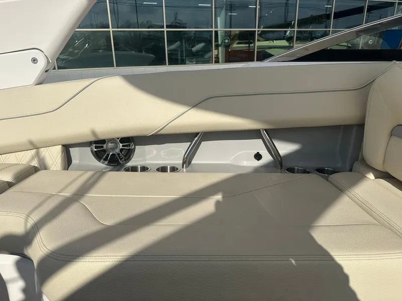 Slide: The Image of 2022 Regal LS4 Surf boat interior with beige seating and speaker detail. - 7