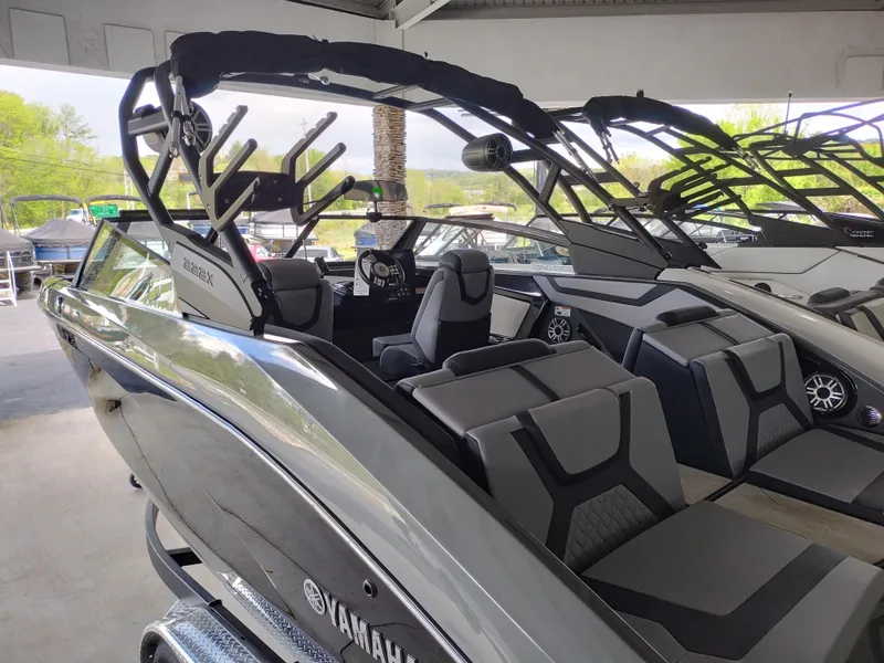 Slide: The Image of 2025 Yamaha Boats 222XD, sleek design, luxury seating, modern dashboard, under covered dock. - 3