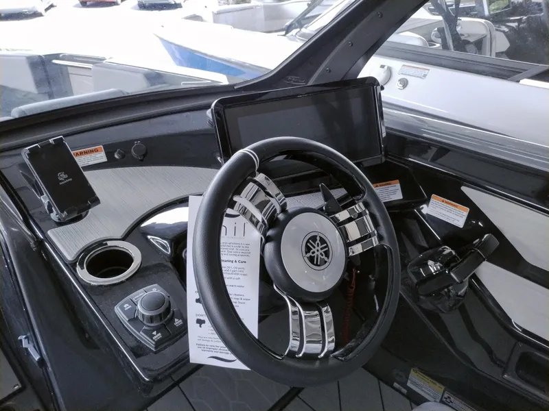 Slide: The Image of 2025 Yamaha Boats 222XD dashboard with steering wheel and control panel. - 4
