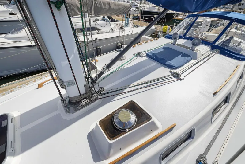 Slide: The Image of 1986 J Boats J/40 sailboat deck with rigging and hatch, docked in a marina. - 17