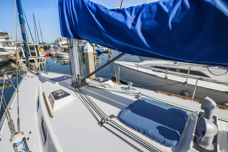 Slide: The Image of 1986 J Boats J/40 sailboat deck with blue sail cover in marina. - 18