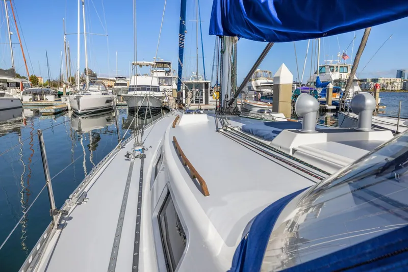 Slide: The Image of 1986 J Boats J/40 sailboat docked in a marina, surrounded by other vessels. - 20