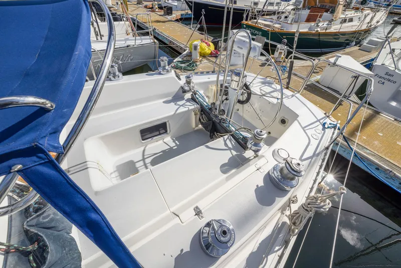 Slide: The Image of 1986 J Boats J/40 sailboat cockpit with winches and blue canopy in marina. - 21