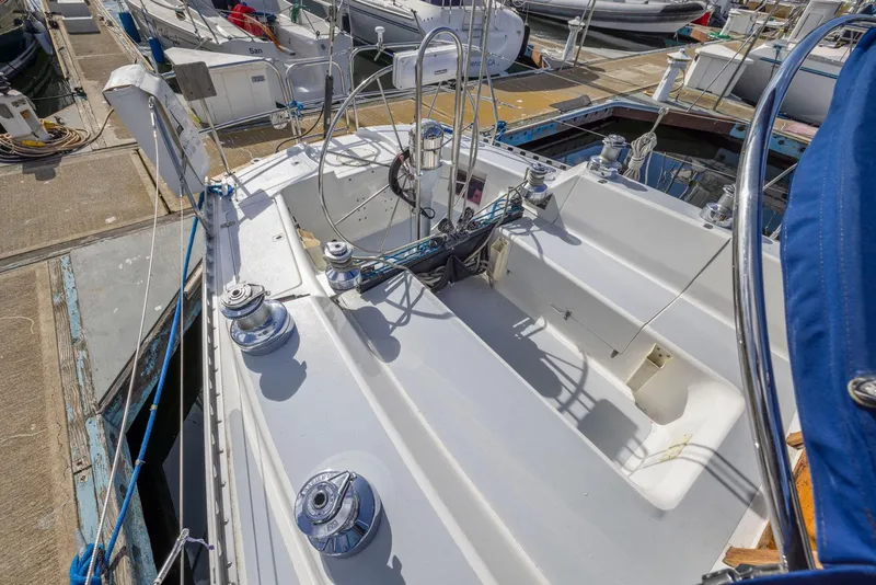 Slide: The Image of 1986 J Boats J/40 sailboat deck with winches and rigging at a marina. - 22