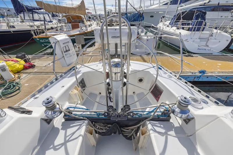 Slide: The Image of Cockpit view of a 1986 J Boats J/40 sailboat docked at a marina. - 26