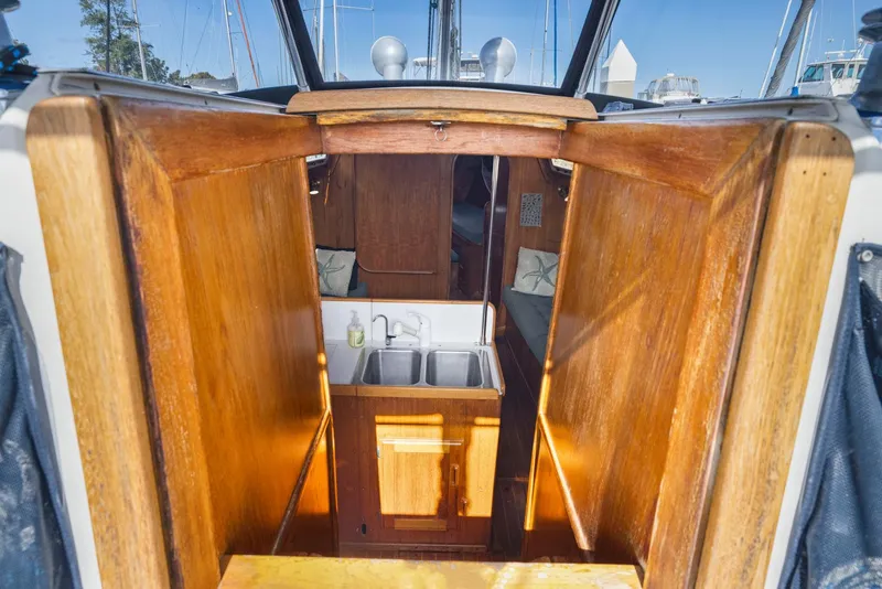Slide: The Image of 1986 J Boats J/40 interior with wooden cabinetry and compact sink area. - 40