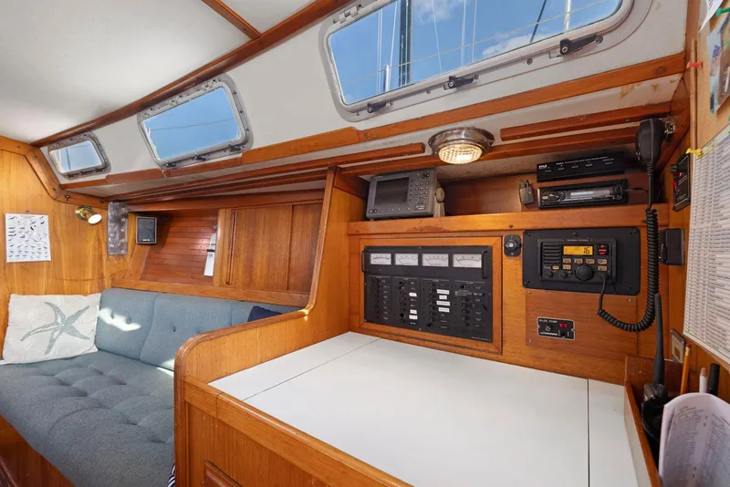 Slide: The Image of Interior of 1986 J Boats J/40 sailboat with navigation station and seating area. - 46