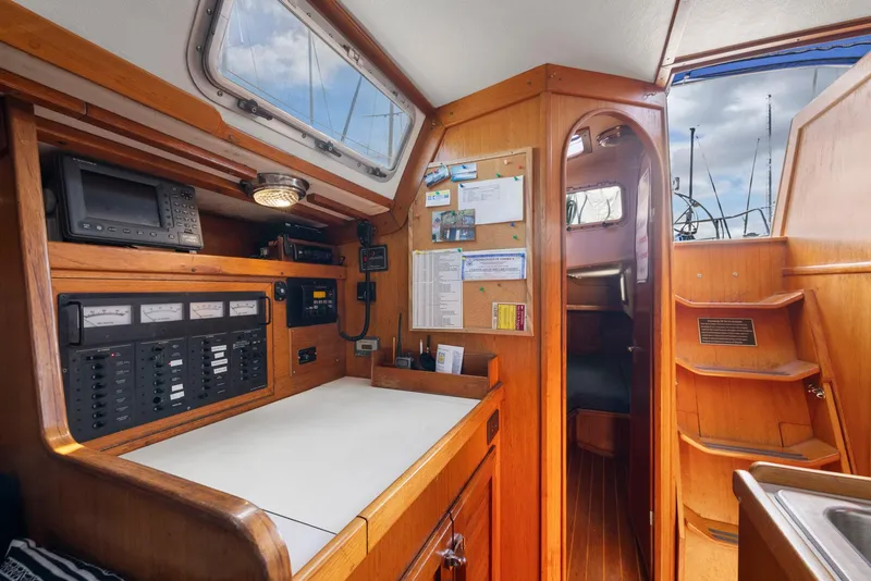 Slide: The Image of Interior of 1986 J Boats J/40 sailboat, featuring navigation station and wooden cabinetry. - 48