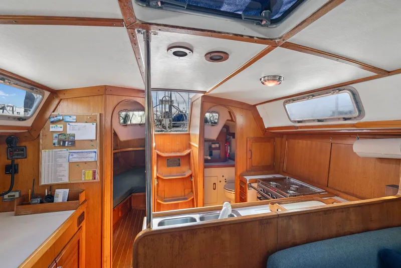Slide: The Image of Interior of 1986 J Boats J/40 sailboat with wood finish and compact kitchen area. - 49