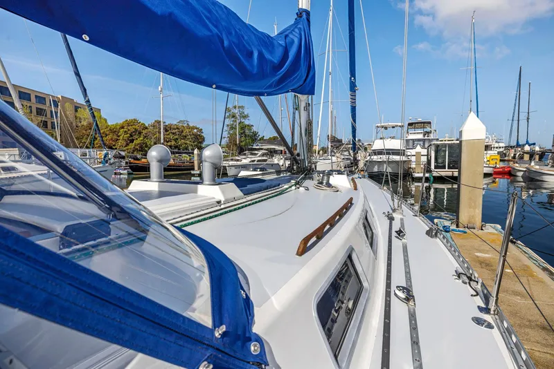 Slide: The Image of 1986 J Boats J/40 sailboat docked at marina, featuring blue sail and clear sky. - 5