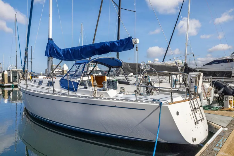 Slide: The Image of 1986 J Boats J/40 sailboat docked at marina under blue sky. - 6
