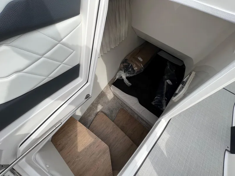 Slide: The Image of Interior cabin view of 2025 Regal 3300 boat, featuring wooden steps and modern design. - 15