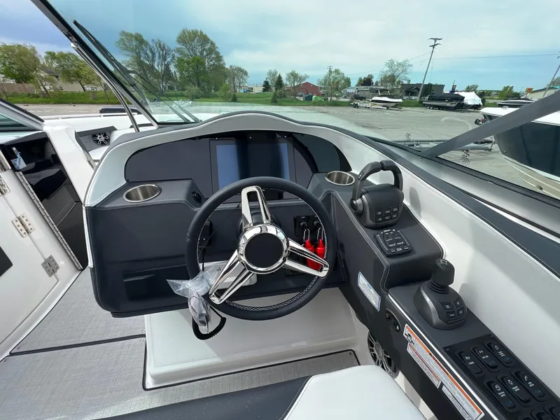 Slide: The Image of 2025 Regal 3300 boat cockpit with modern steering and control panel. - 5