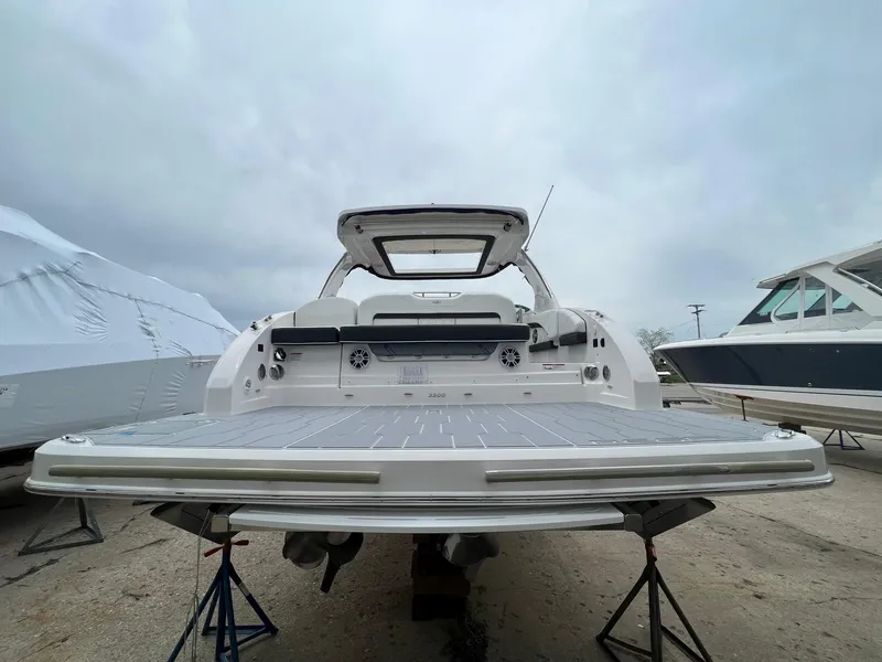 Slide: The Image of 2025 Regal 3300 boat on stands, rear view, overcast sky. - 6