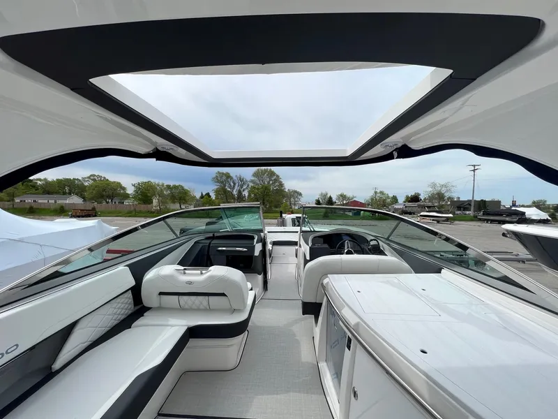 Slide: The Image of 2025 Regal 3300 boat interior with sleek seating and open sunroof design. - 9