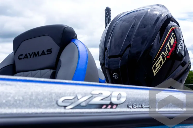 Slide: The Image of 2025 Caymas CX 20 PRO boat with sleek design and helmet on seat. - 18