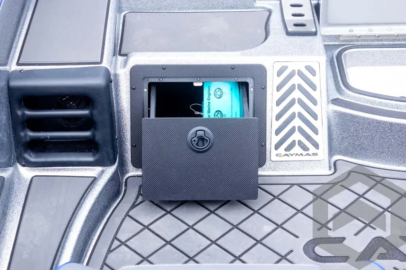 Slide: The Image of 2025 Caymas CX 20 PRO boat storage compartment with open hatch and visible contents. - 42