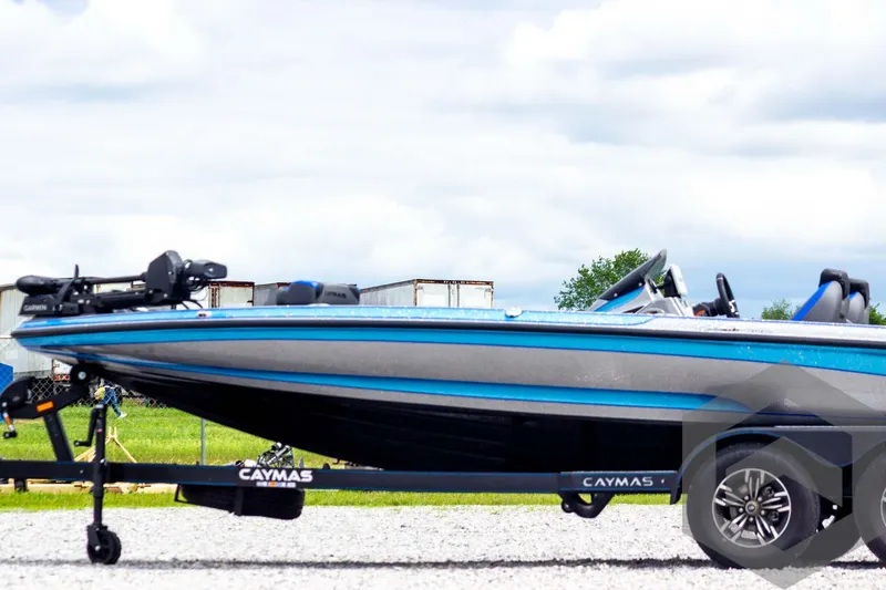 Slide: The Image of 2025 Caymas CX 20 PRO boat on trailer, blue and gray design, parked outdoors. - 9