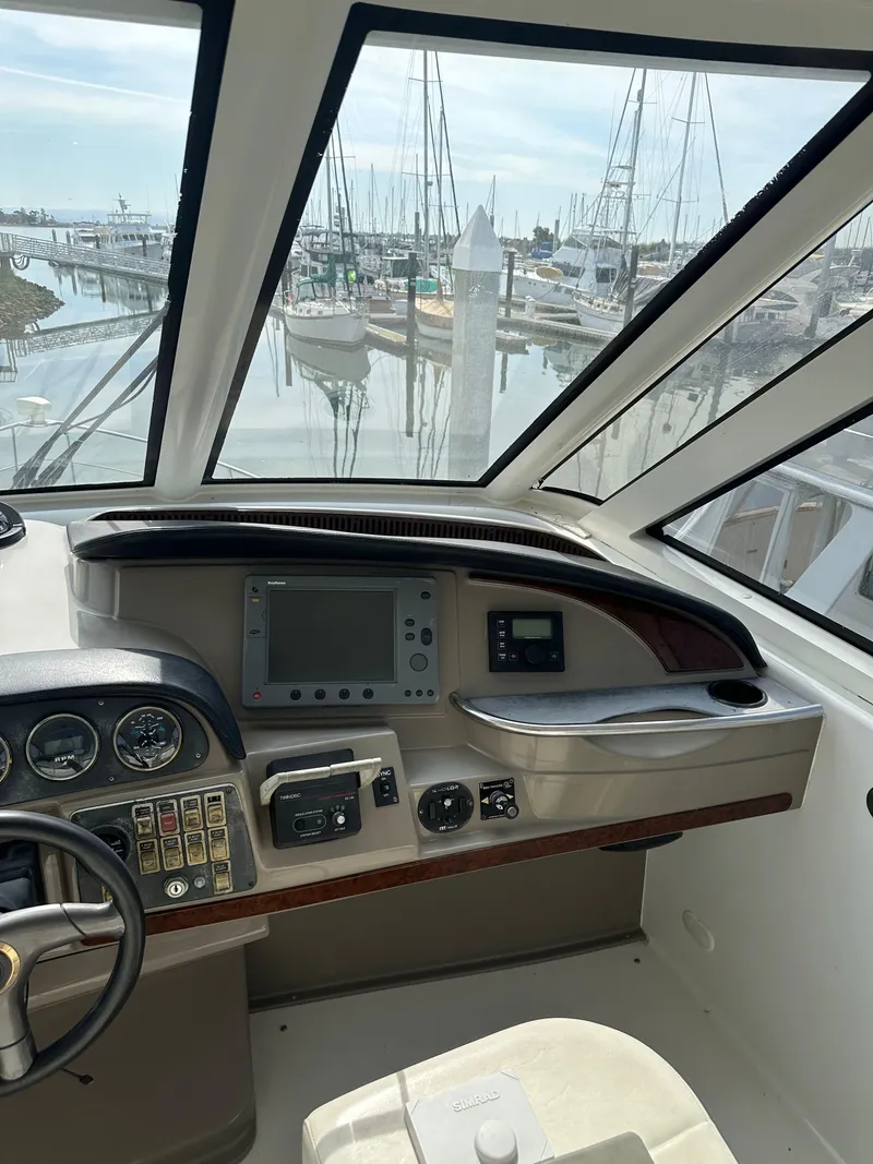 Slide: The Image of Interior helm of 2000 Carver 506 Motor Yacht with marina view. - 13