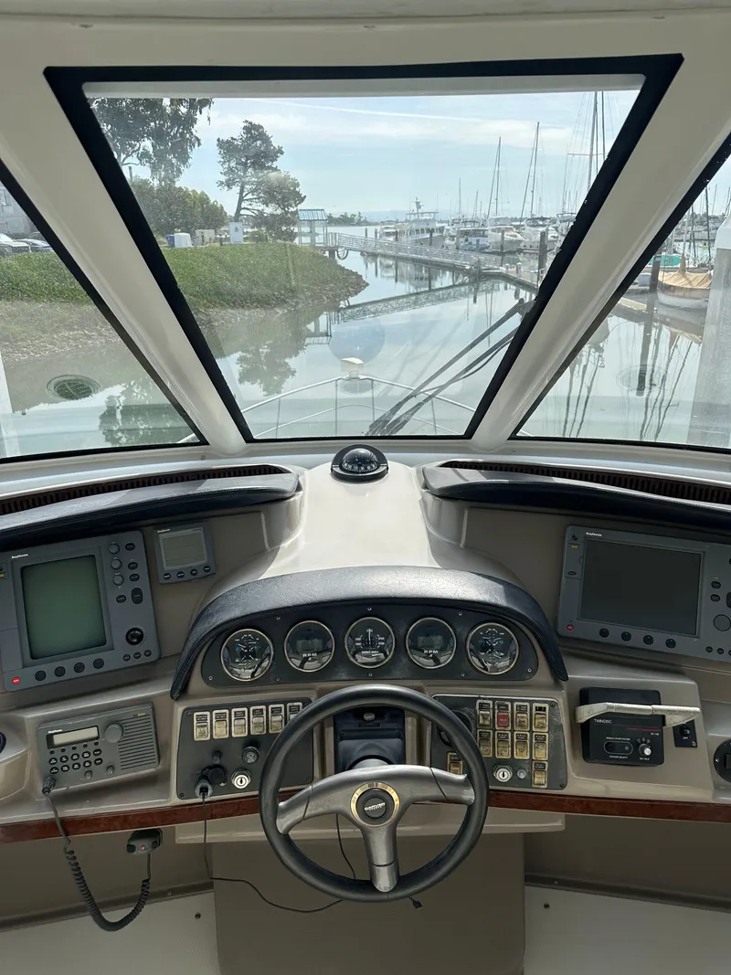 Slide: The Image of Helm of 2000 Carver 506 Motor Yacht with marina view through windshield. - 14