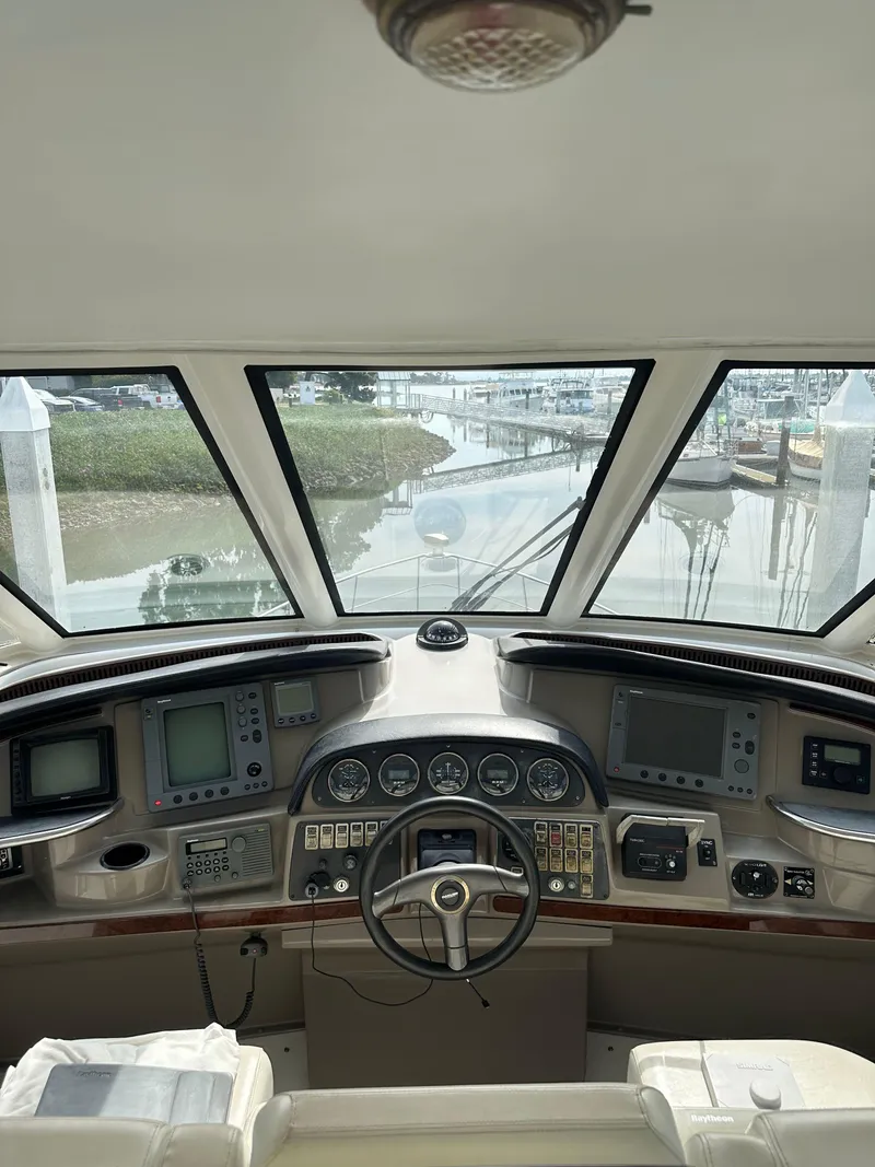 Slide: The Image of Interior helm of 2000 Carver 506 Motor Yacht with navigational instruments and steering wheel. - 16