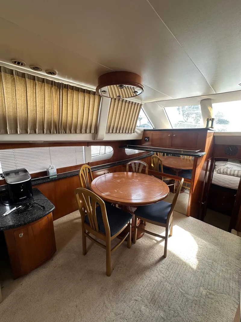 Slide: The Image of Interior of 2000 Carver 506 Motor Yacht with dining area and wooden furnishings. - 21