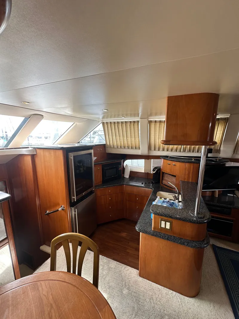 Slide: The Image of Interior of 2000 Carver 506 Motor Yacht with modern kitchen and dining area. - 22